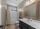 Clean bathroom features a shower-tub combo and vanity sink with a large framed mirror at 191 Harris Farm Rd, Mooresville, NC 28115