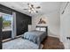 Simple bedroom with a black accent wall, and an oversized ceiling fan at 191 Harris Farm Rd, Mooresville, NC 28115