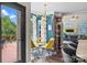 Bright breakfast nook with glass table, yellow chairs, hardwood flooring, and modern chandelier at 191 Harris Farm Rd, Mooresville, NC 28115