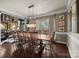 Elegant dining room with a long wooden table, crystal chandelier, and refined decor at 191 Harris Farm Rd, Mooresville, NC 28115