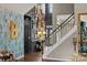 Grand foyer with an eye-catching gallery wall, hardwood floors, and a staircase to the upper level at 191 Harris Farm Rd, Mooresville, NC 28115