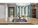 Modern kitchen island with double sink and a view of the light-filled dining area at 191 Harris Farm Rd, Mooresville, NC 28115