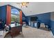 Cozy room with a desk and a window and a small display cabinet on a blue wall at 191 Harris Farm Rd, Mooresville, NC 28115