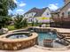 Backyard pool and spa with waterfall feature and ample seating, perfect for relaxing and entertaining guests at 191 Harris Farm Rd, Mooresville, NC 28115