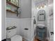 Charming powder room featuring unique vanity, decor, and wainscoting details at 191 Harris Farm Rd, Mooresville, NC 28115
