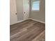 Bedroom featuring updated hardwood flooring, paint, and a window providing natural light at 2321 Cline St, Statesville, NC 28677