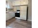 A functional kitchen featuring white cabinets, laminate flooring, and essential appliances at 2321 Cline St, Statesville, NC 28677