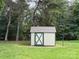 A small outdoor shed is set against a backdrop of mature trees, offering practical storage at 2321 Cline St, Statesville, NC 28677
