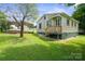 Side view showing access to the home and a metal carport, with a well-kept lawn at 2321 Cline St, Statesville, NC 28677