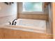 Bathroom with a clean white bathtub featuring tile surround, and bronze fixtures at 233 Highland Forest Dr, Clover, SC 29710