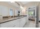 Bathroom with double sinks, granite counters, white cabinets, and modern lighting at 233 Highland Forest Dr, Clover, SC 29710