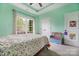 Charming bedroom with a large window, floral bedding, and mint green walls at 233 Highland Forest Dr, Clover, SC 29710