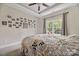 Sunny bedroom with a large window, many photos on the wall, and a patterned bed spread at 233 Highland Forest Dr, Clover, SC 29710