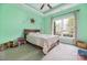 Bright bedroom featuring a bed, a large window, and vibrant mint green walls at 233 Highland Forest Dr, Clover, SC 29710