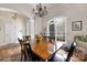 Bright dining room boasts a wooden table and large arched window overlooking the backyard at 233 Highland Forest Dr, Clover, SC 29710
