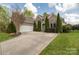 Attractive brick home showcasing manicured landscaping, a paved driveway, and an attached two-car garage at 233 Highland Forest Dr, Clover, SC 29710