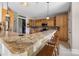 Open-concept kitchen featuring granite countertops, wooden cabinets, and seating at bar at 233 Highland Forest Dr, Clover, SC 29710