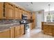 Well-lit kitchen featuring stainless steel appliances, granite countertops, and wooden cabinetry at 233 Highland Forest Dr, Clover, SC 29710