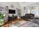 Well-lit living room featuring hardwood floors, vaulted ceiling, and a large media center at 233 Highland Forest Dr, Clover, SC 29710