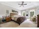 Large main bedroom with tray ceilings, decorative windows, and neutral carpeting at 233 Highland Forest Dr, Clover, SC 29710