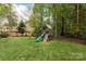 Backyard featuring wooden playground and lush green lawn at 233 Highland Forest Dr, Clover, SC 29710