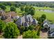 Beautiful aerial view of a luxury home with a stone roof and lush green landscaping at 300 Eagle Bend Dr, Waxhaw, NC 28173