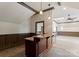 Wet bar with stone countertop and paneling, featuring neutral carpet at 300 Eagle Bend Dr, Waxhaw, NC 28173