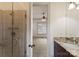 Bathroom featuring tile shower and vanity; an open door leads to a bedroom with a ceiling fan at 300 Eagle Bend Dr, Waxhaw, NC 28173