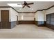 Bright bedroom with paneled walls, neutral carpet, skylight, and a ceiling fan at 300 Eagle Bend Dr, Waxhaw, NC 28173
