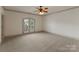Spacious bedroom featuring a ceiling fan, neutral carpet, and bright french doors leading to the exterior at 300 Eagle Bend Dr, Waxhaw, NC 28173