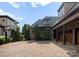 View of the motor court, carriage garage, and basketball hoop on a meticulously landscaped lot at 300 Eagle Bend Dr, Waxhaw, NC 28173