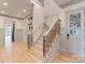 Elegant foyer with a staircase featuring iron railings and hardwood floors, creating a grand entrance at 300 Eagle Bend Dr, Waxhaw, NC 28173