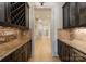 Hallway with wine rack, bar, and hardwood floors, creating an elegant transition between spaces at 300 Eagle Bend Dr, Waxhaw, NC 28173