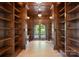 Wood-paneled library with arched entry and floor-to-ceiling shelving at 300 Eagle Bend Dr, Waxhaw, NC 28173