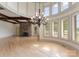 Living room boasting a stone fireplace, high ceilings, abundant natural light, and hardwood floors at 300 Eagle Bend Dr, Waxhaw, NC 28173