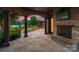 Covered outdoor patio with a brick fireplace, TV, and stone flooring, perfect for relaxation and entertaining at 300 Eagle Bend Dr, Waxhaw, NC 28173