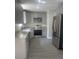 Updated kitchen boasts stainless steel appliances, granite countertops, gray cabinets, and modern flooring at 961 Poplar Forest Rdg, Clover, SC 29710