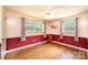 A sunlit bedroom with natural light has chair-rail molding and hardwood floors at 1008 2Nd Se St, Conover, NC 28613