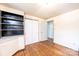 A tidy bedroom is showcased, featuring hardwood floors and a built-in shelving unit at 1008 2Nd Se St, Conover, NC 28613