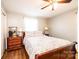 Comfortable bedroom featuring hardwood floors, a floral-patterned bedspread, and matching nightstands at 1008 2Nd Se St, Conover, NC 28613