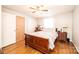 Bedroom featuring hardwood floors, a floral bedspread, and matching nightstands flanking the bed at 1008 2Nd Se St, Conover, NC 28613