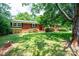 Charming brick home features a well-manicured lawn and mature shade trees at 1008 2Nd Se St, Conover, NC 28613