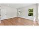 Bright bedroom featuring wood-look floors, natural light, and neutral paint at 1017 S Main St, Granite Quarry, NC 28146