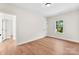 Bright bedroom features light wood floors, white walls, a closet, and a window at 1017 S Main St, Granite Quarry, NC 28146