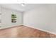 Bright bedroom features light wood floors and white walls, ready for personal touches at 1017 S Main St, Granite Quarry, NC 28146