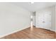 Spacious bedroom features light wood floors, closet, white walls, and ample space at 1017 S Main St, Granite Quarry, NC 28146