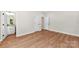 Well-lit bedroom featuring wood-look floors, two interior doors, and neutral walls at 1017 S Main St, Granite Quarry, NC 28146