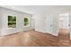 Bright bedroom with hardwood floors, two windows, and neutral paint at 1017 S Main St, Granite Quarry, NC 28146