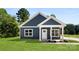 Charming blue home with white trim, well-manicured lawn, and inviting entrance at 1017 S Main St, Granite Quarry, NC 28146