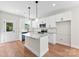 Modern kitchen featuring white cabinetry, stainless steel appliances, and a center island with granite countertops at 1017 S Main St, Granite Quarry, NC 28146